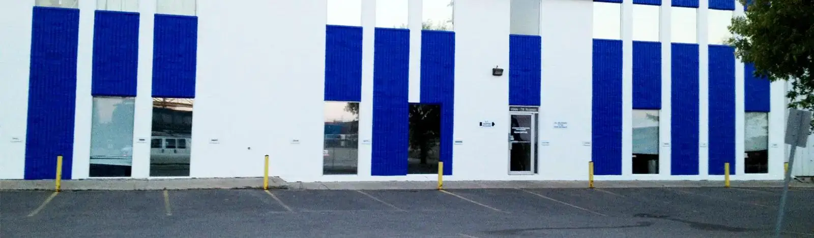 industrial building exterior painted blue and white